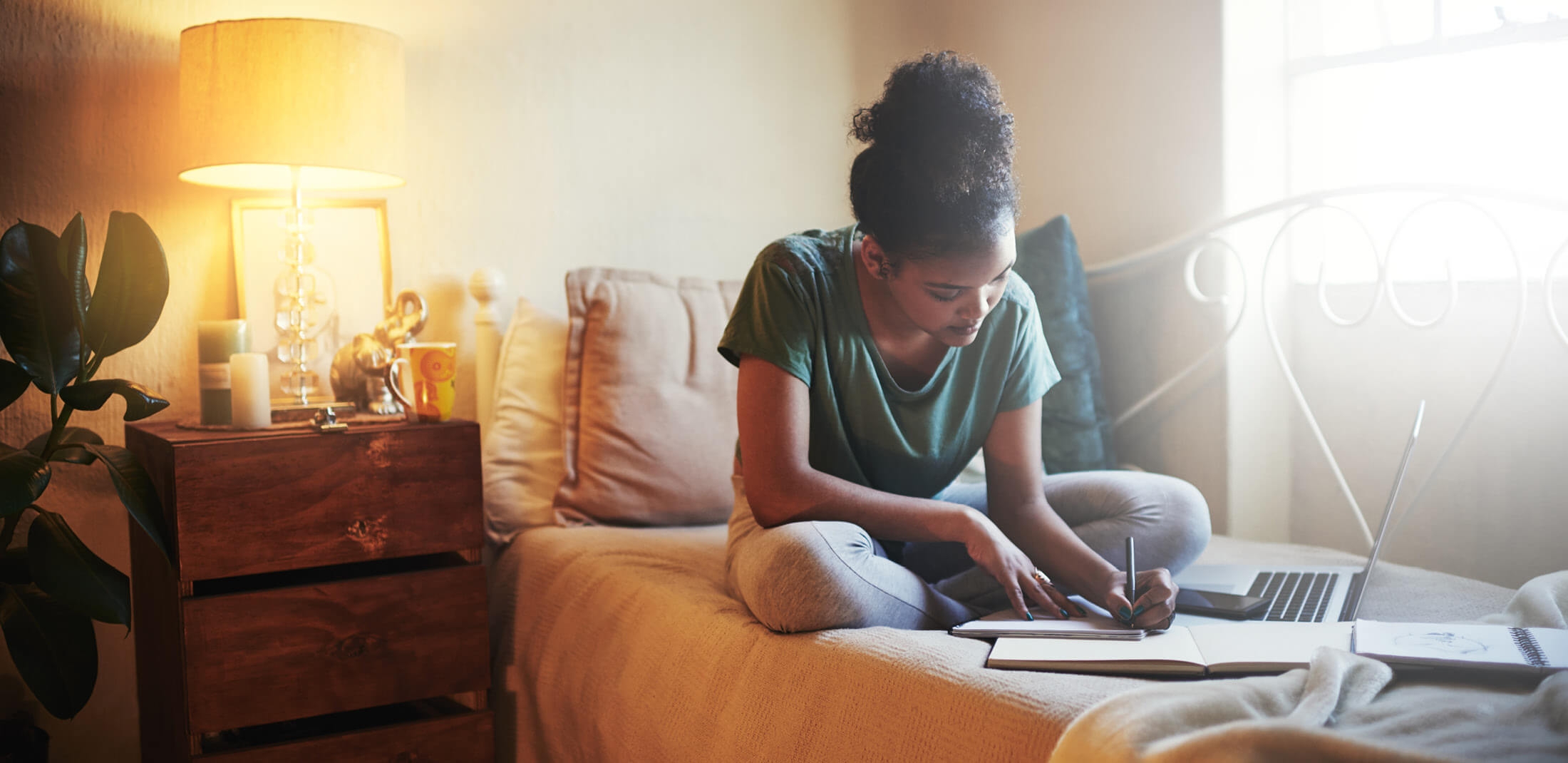 a women studying on a bed