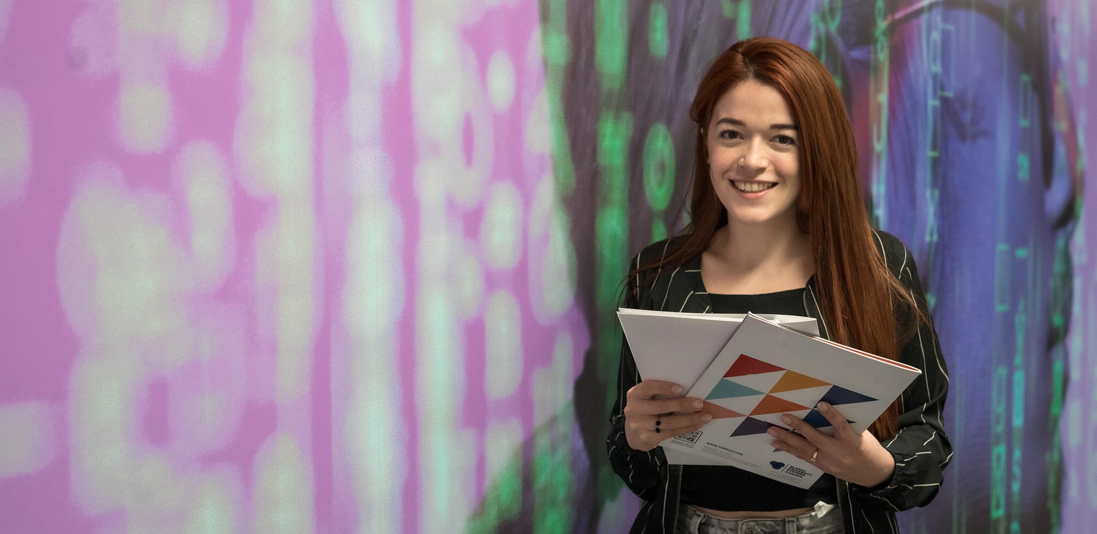 a student holding books and documents