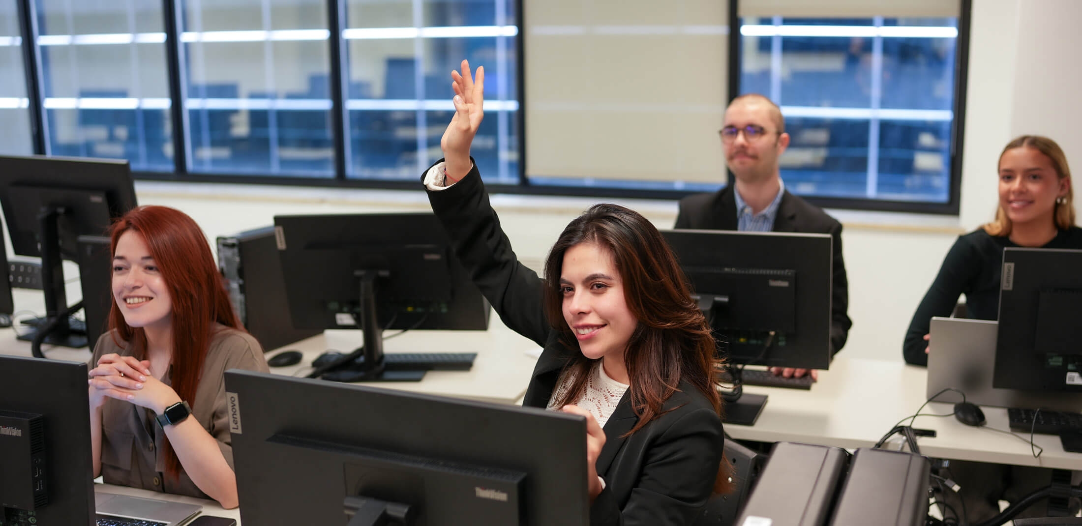 a student raising her hand to ask question