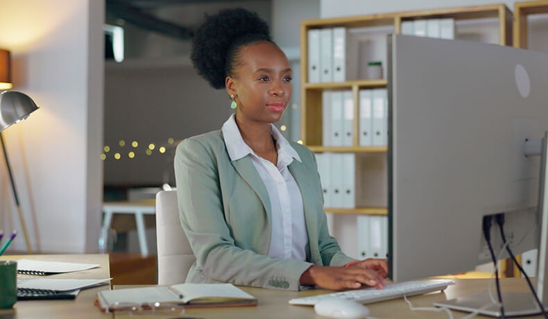 Women working on a desk and typing