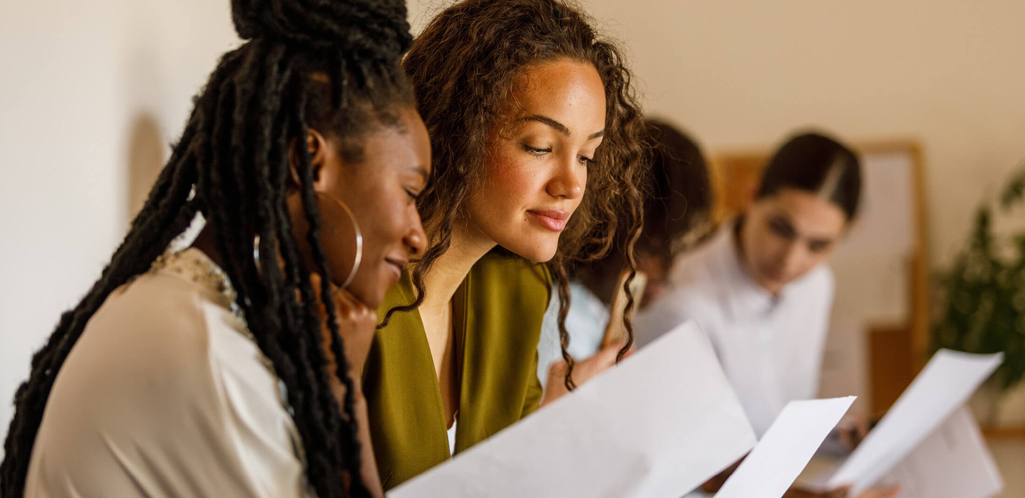 women looking at papers